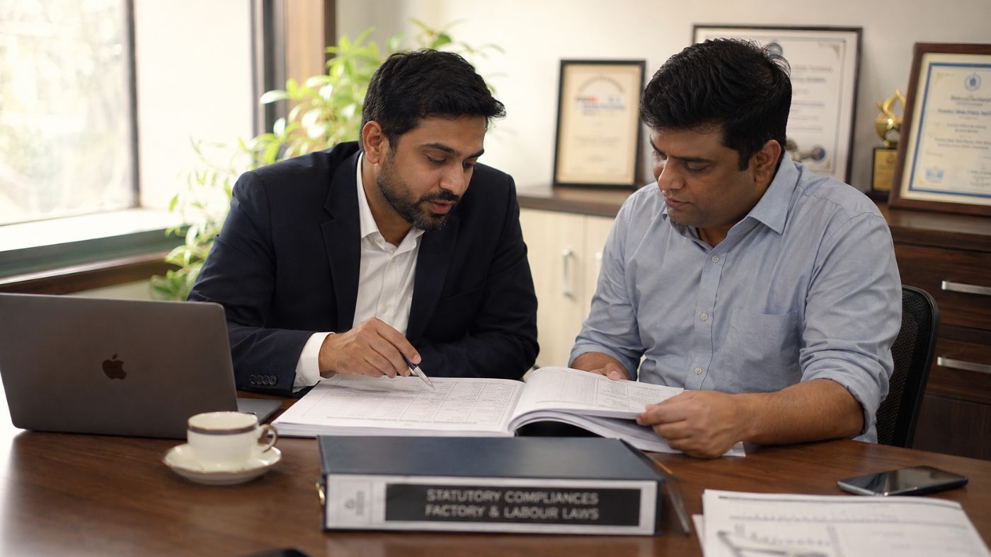Consultants reviewing an establishment's statutory compliance details